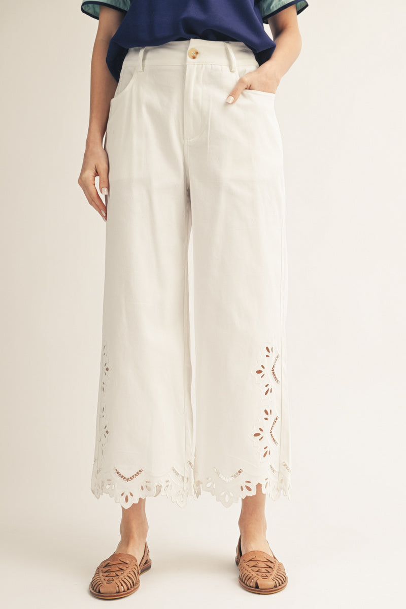 White cropped pants with eyelet hem detail