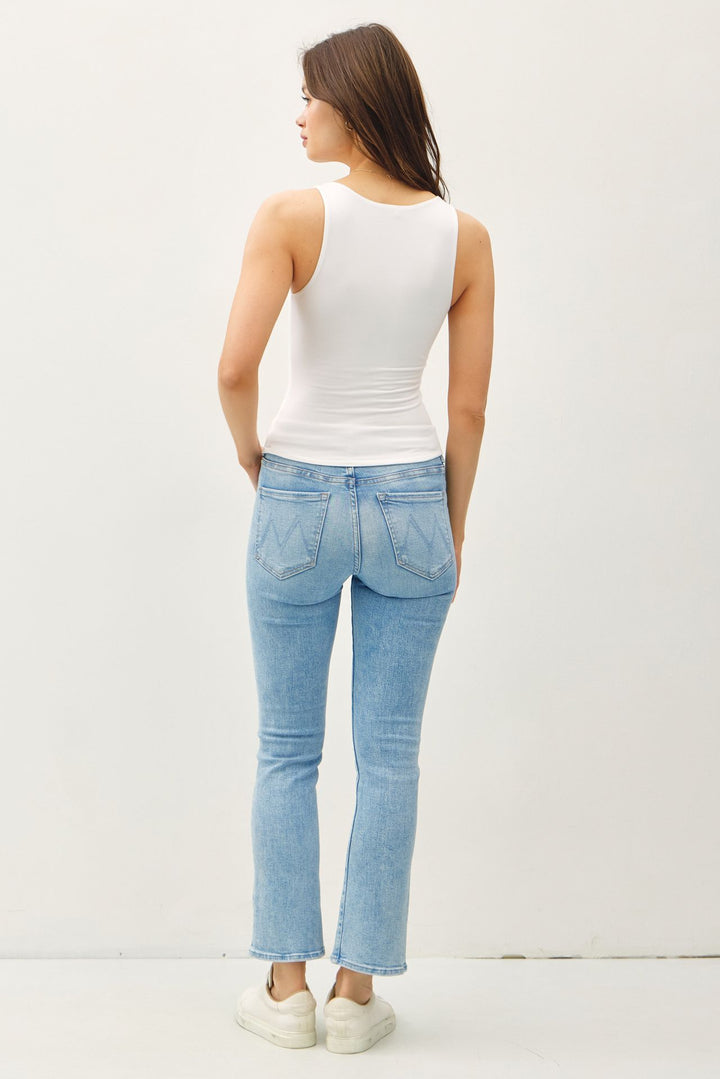 Women’s sleeveless knit top styled with jeans