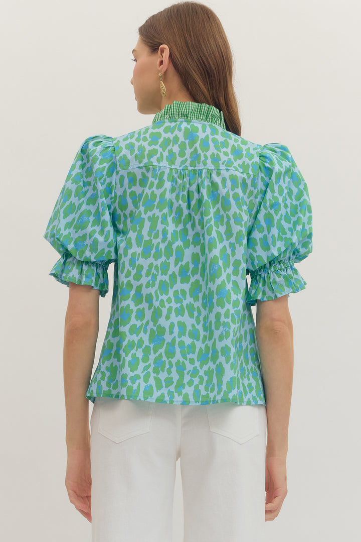 Colorful boutique blouse styled with white pants